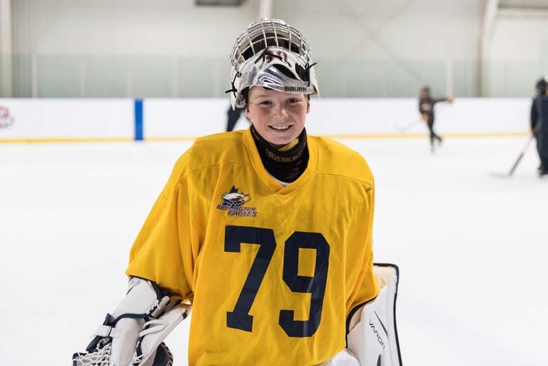 Happy goalie smiling playing hockey.