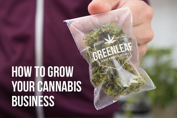 Man holding a bag of marijuana with a custom clear logo sticker on the bag