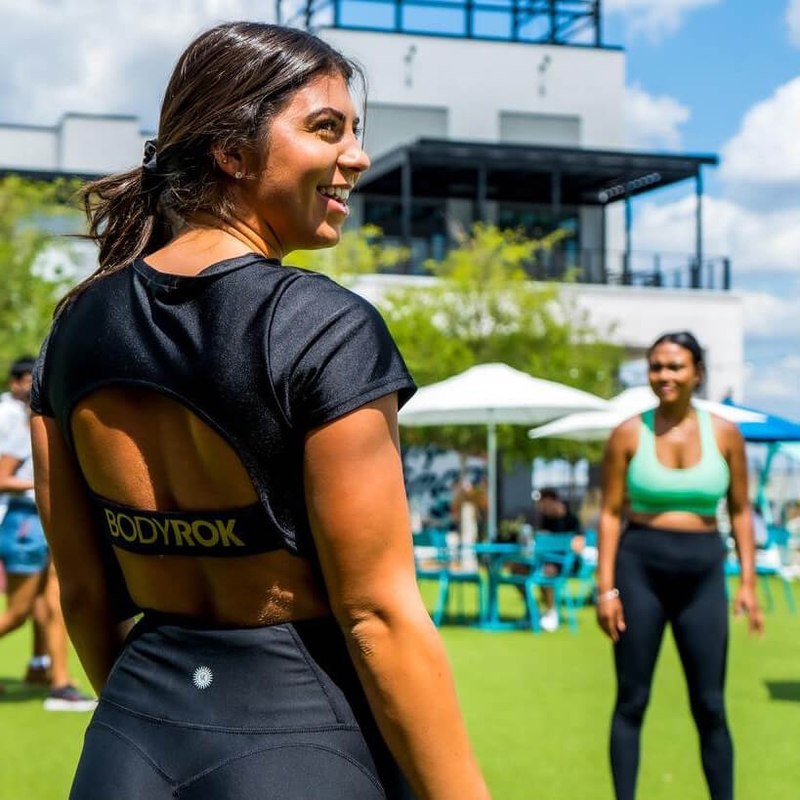 two women outside in work out clothing
