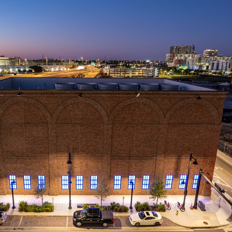 evening ariel photo of building and parked cars