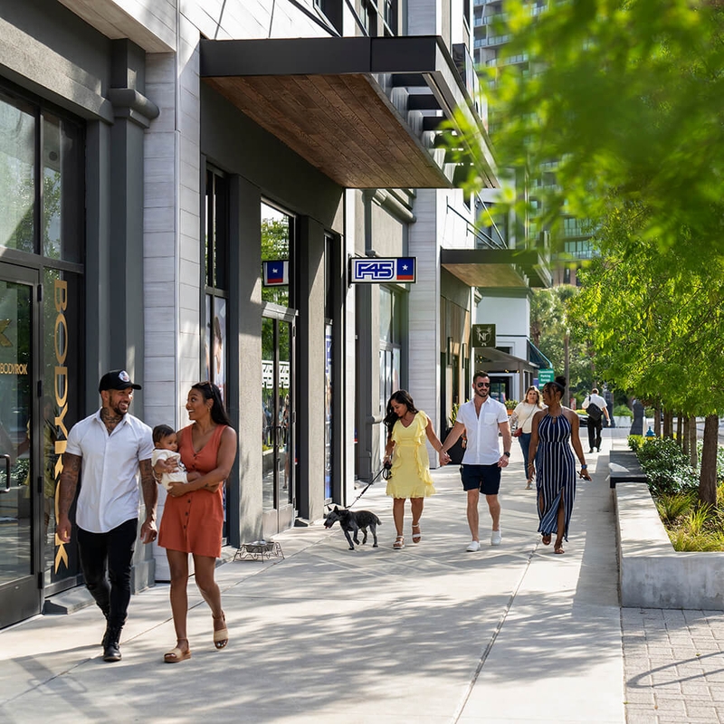 people walking on sidewalk in front of building