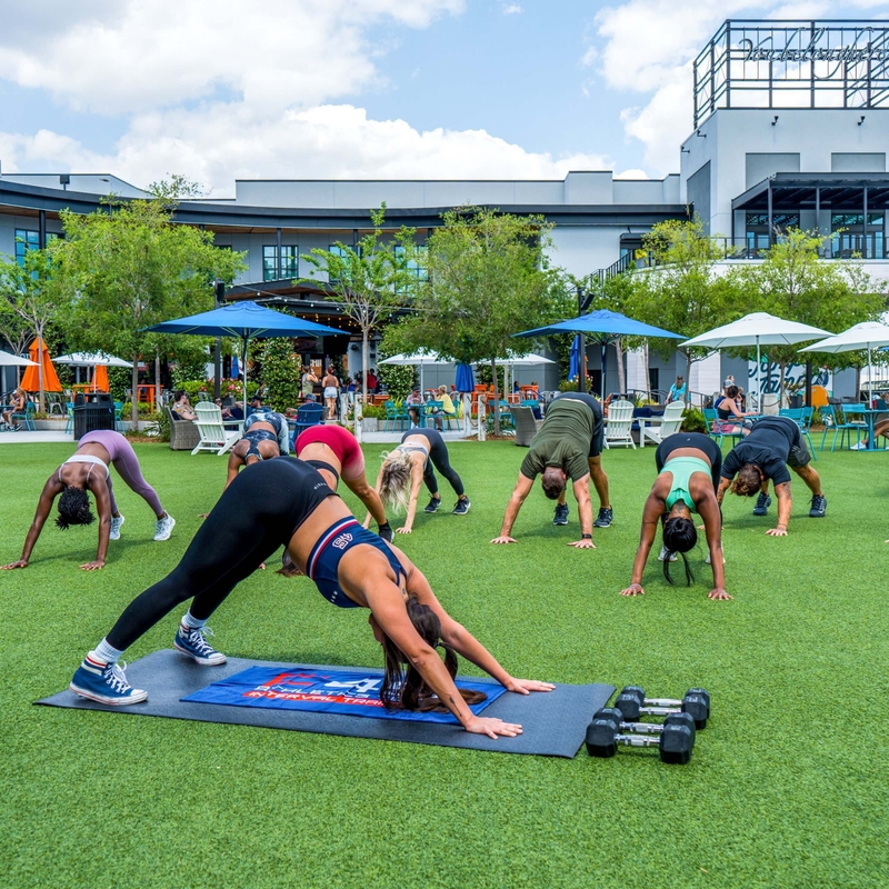 group of people doing yoga in a park