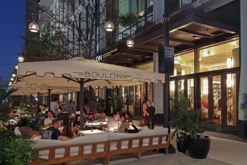 photo of a group of diners at an outdoor patio in the evening