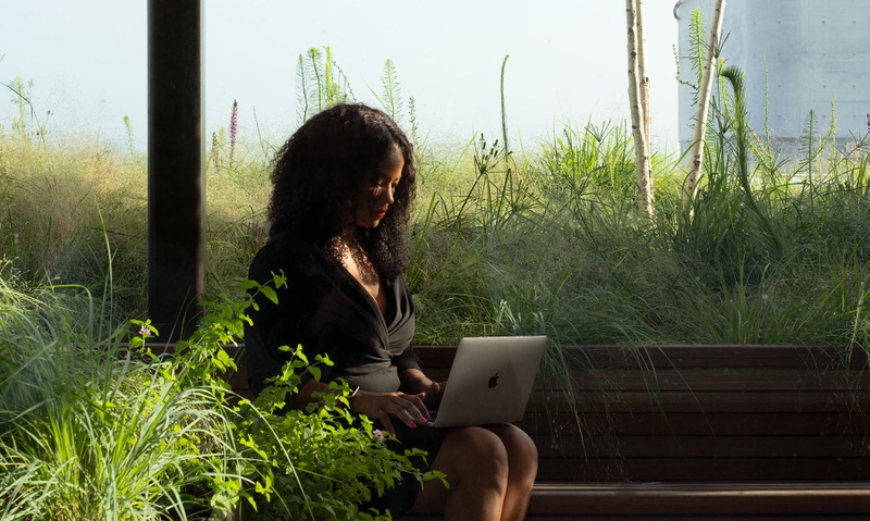 woman working on a computer outdoors 