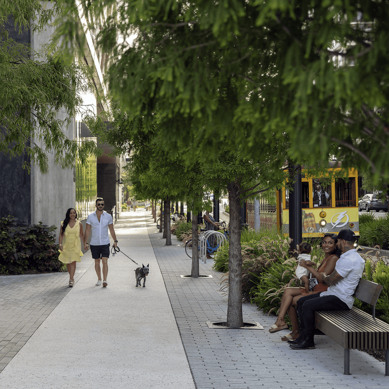 pedestrians walking downtown on retail strip