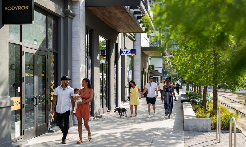 pedestrians walking downtown on retail strip
