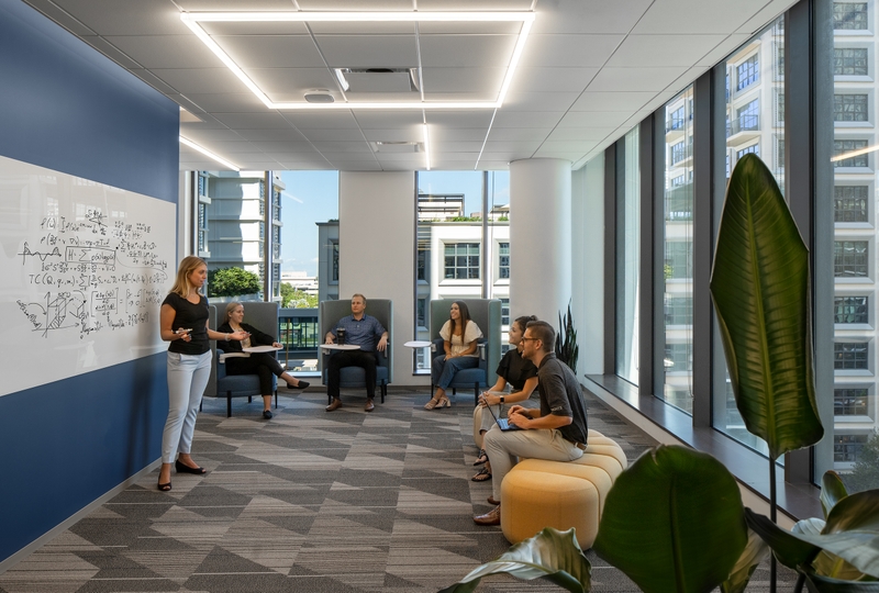 employees collaborating using a whiteboard