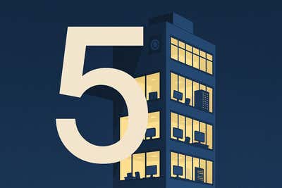 The number 5 over a building with the lights on and computers inside