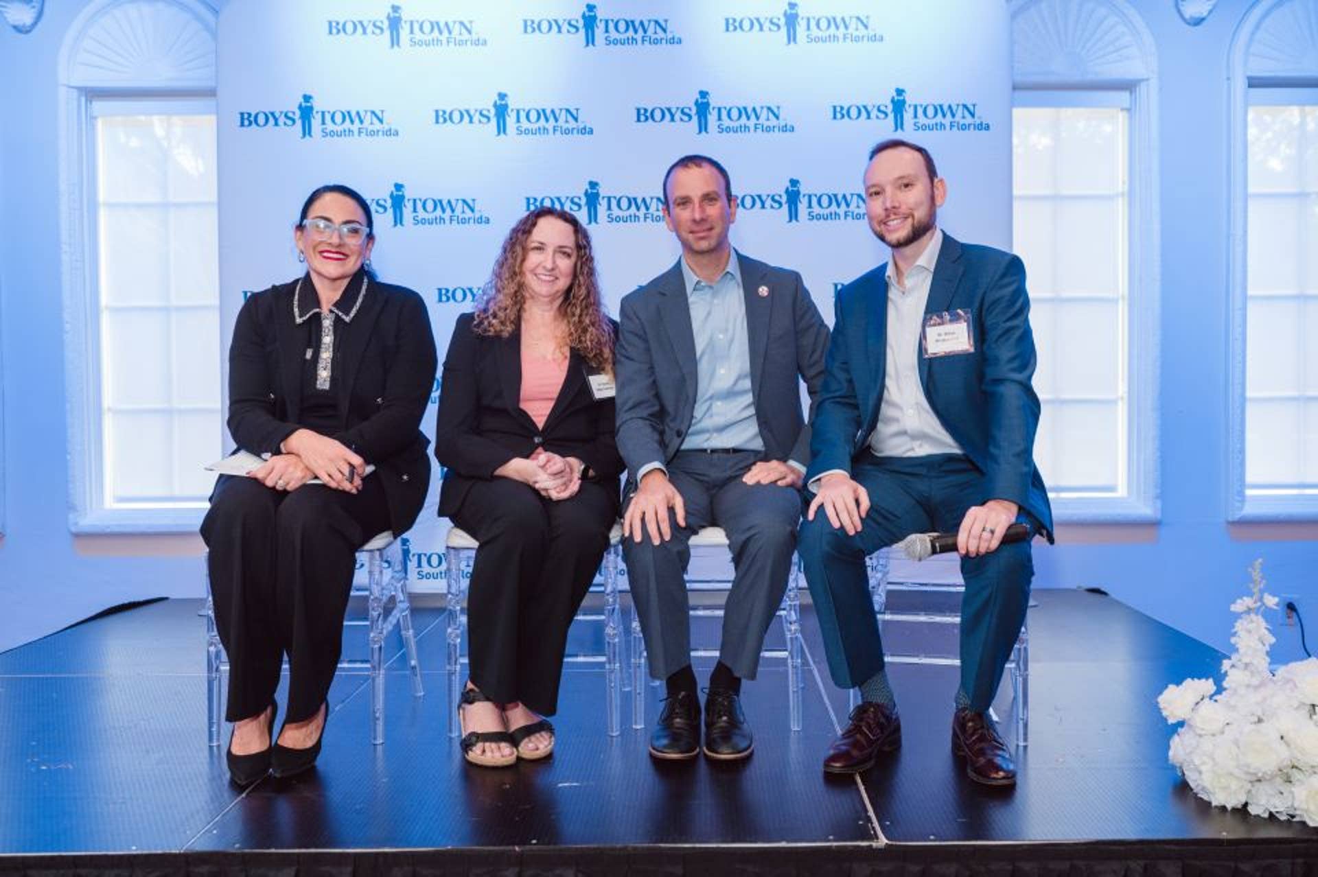 All the panelist on the stage Michelle Goncalves Fleming, Dr. Diane Kelly Andreou, Gregory Schiller, and Dr. Steve Arcidiacono
