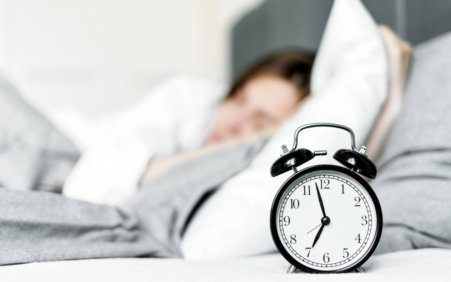 Alarm Clock in front of someone sleeping