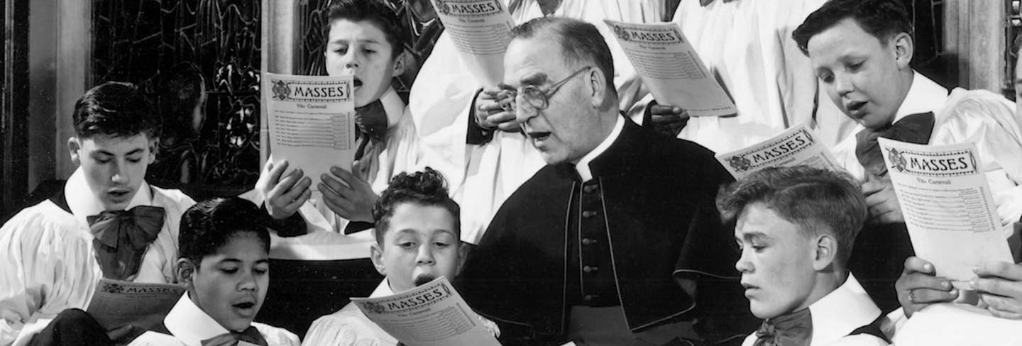 Father Flanagan singing with the choir