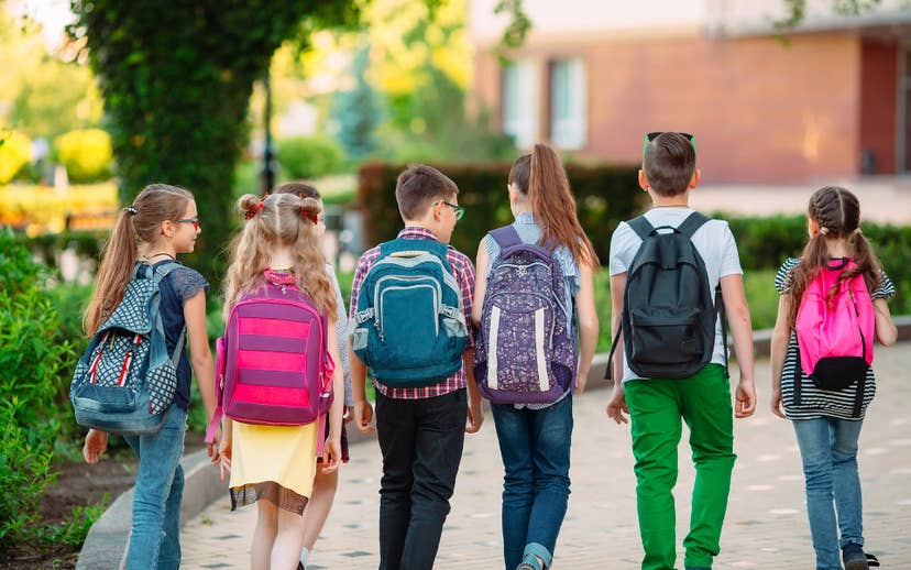 Six youth with Backpacks on walking together