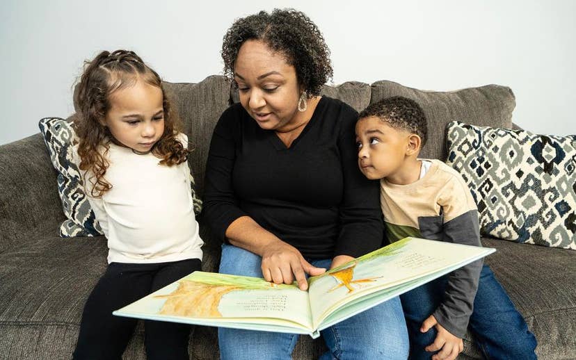 Mom and two kids reading a book
