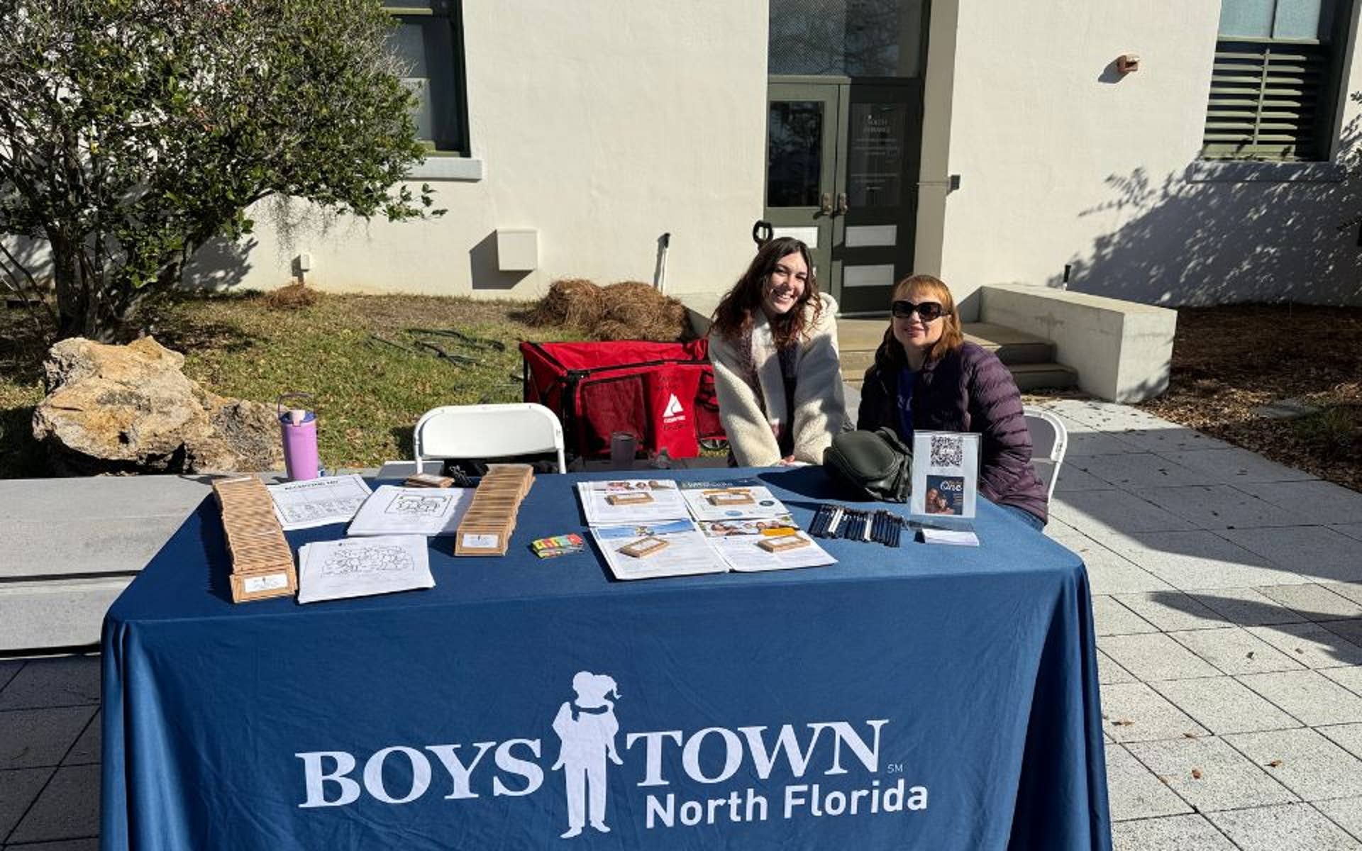 2 Women at Boys Town Table for Children's Day