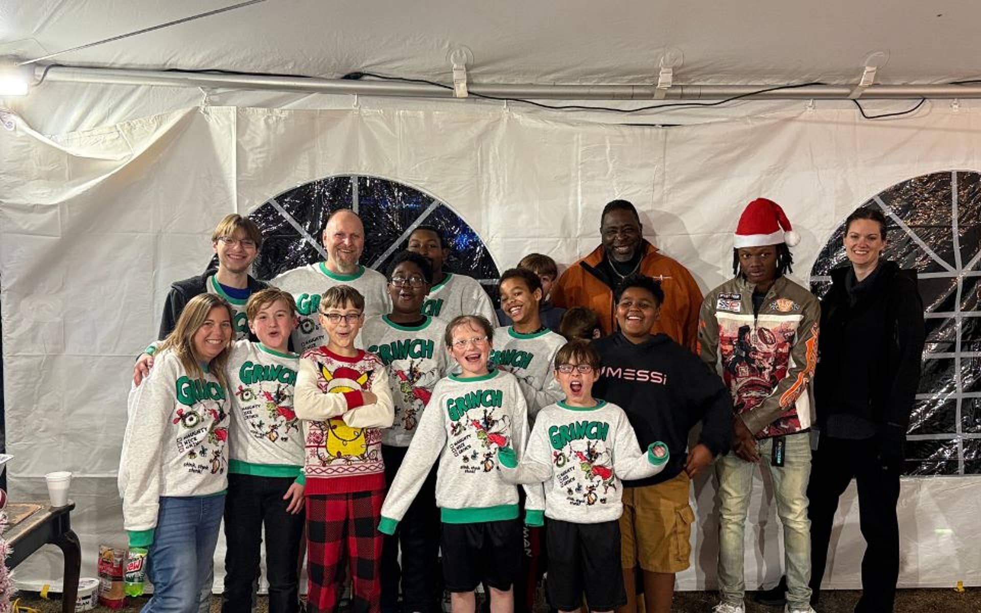 Youth and Adults wearing matching Christmas sweaters