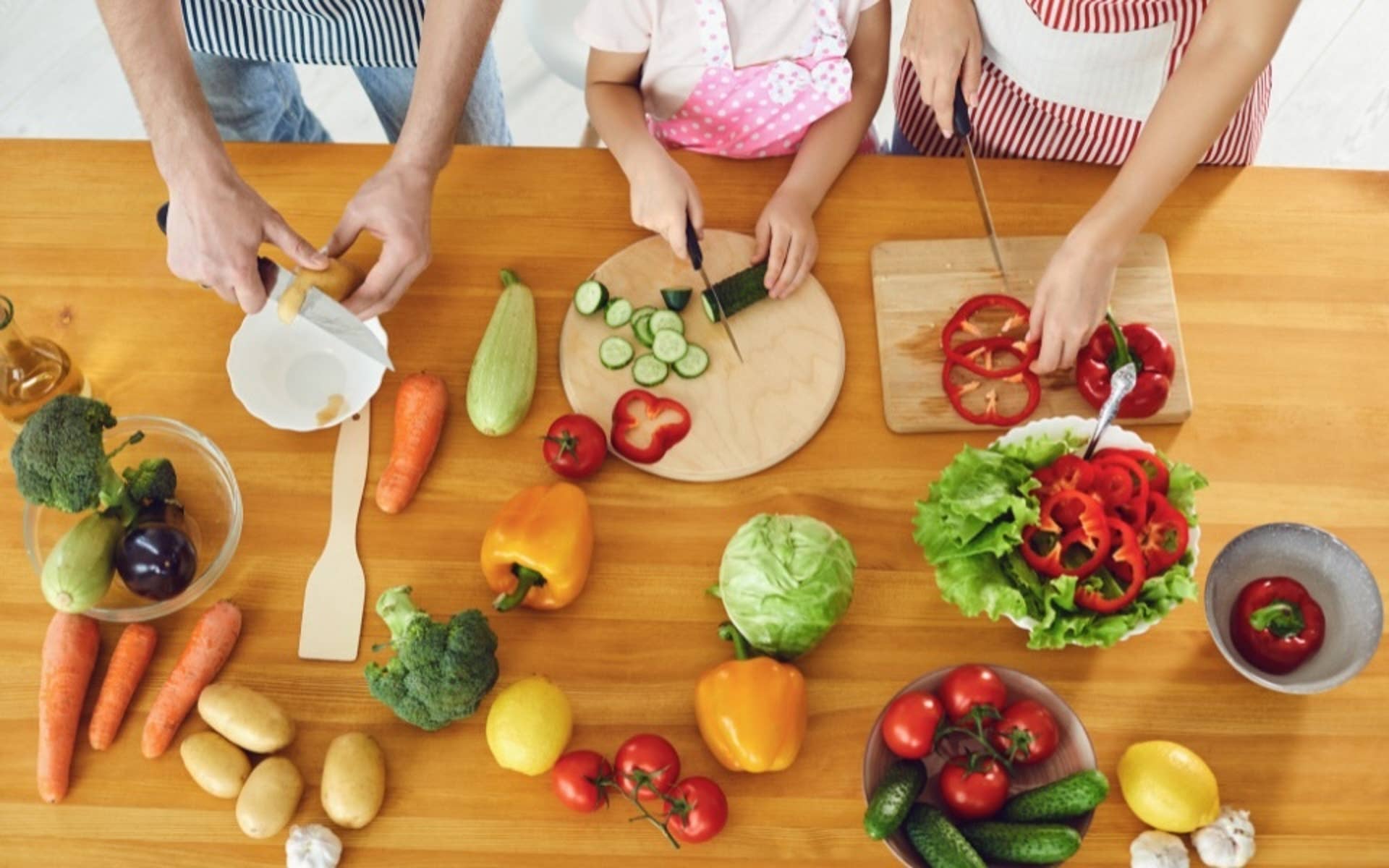 family cutting vegatables together