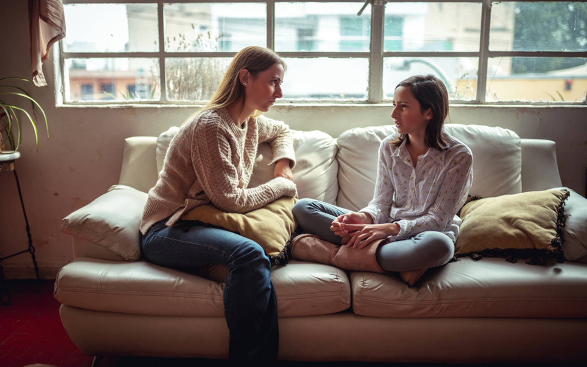 Youth and Parent sitting on couch talking