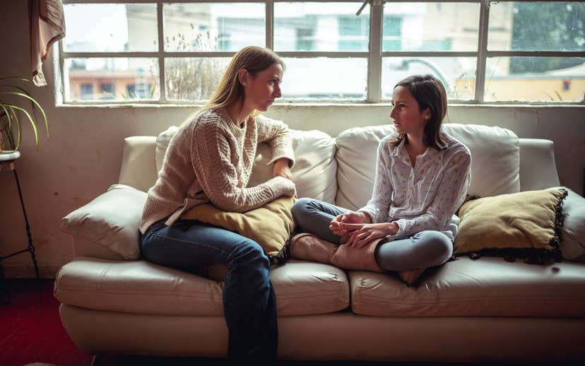 Youth and Parent sitting on couch talking