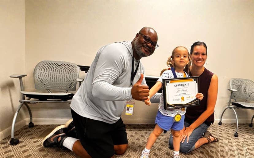  Two adults and youth holding a certificate