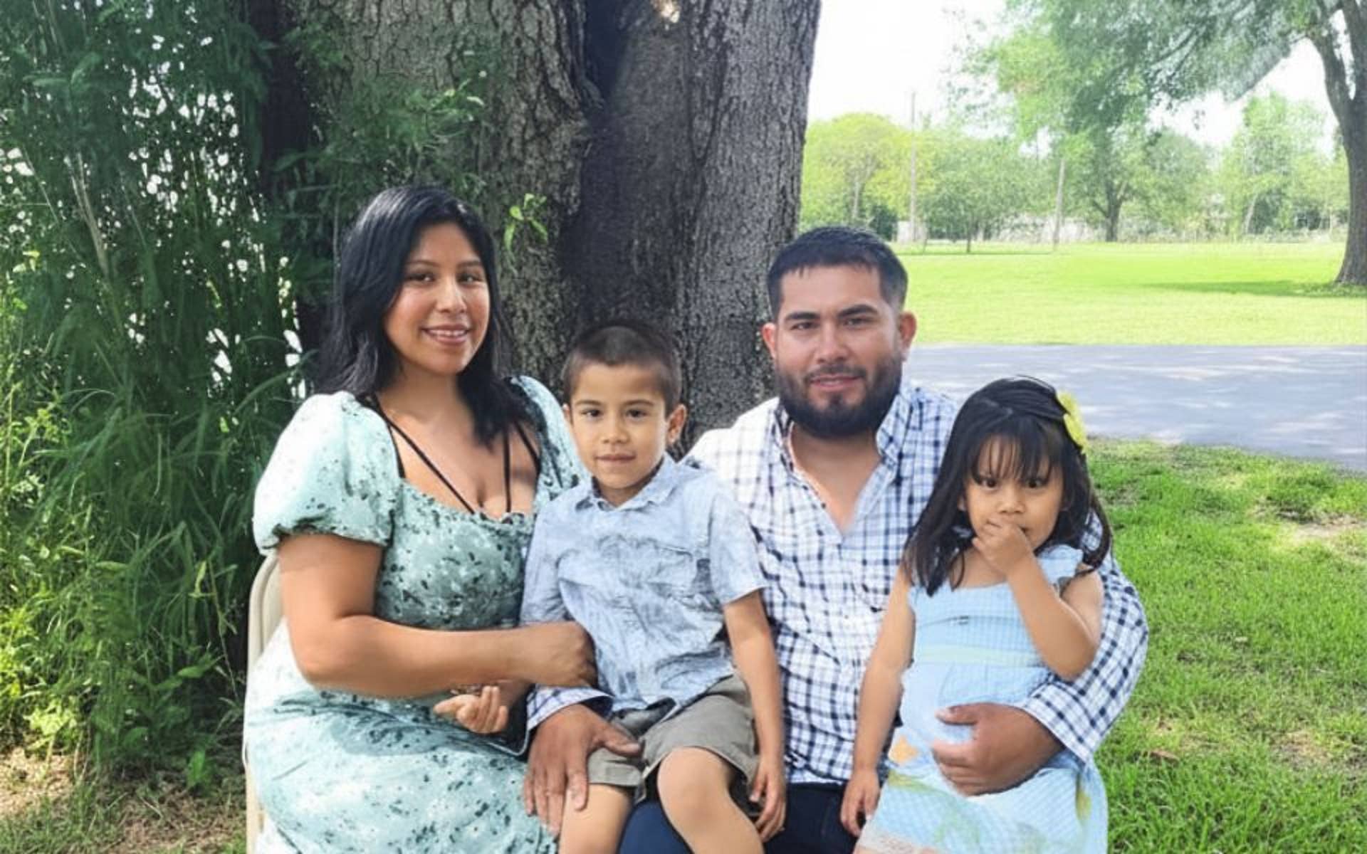 Flores Family in front of a tree