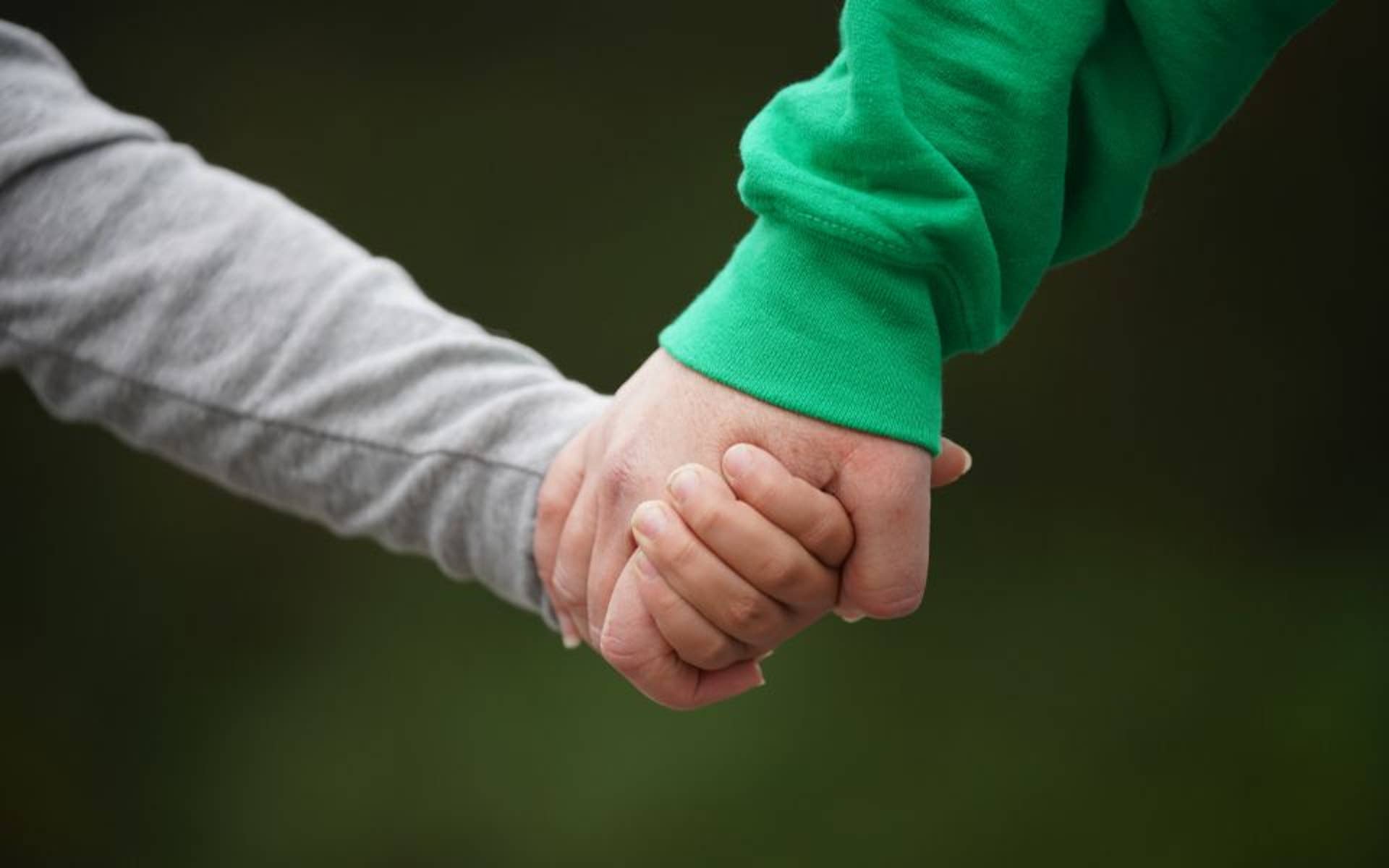 Youth and Adult Holding Hands