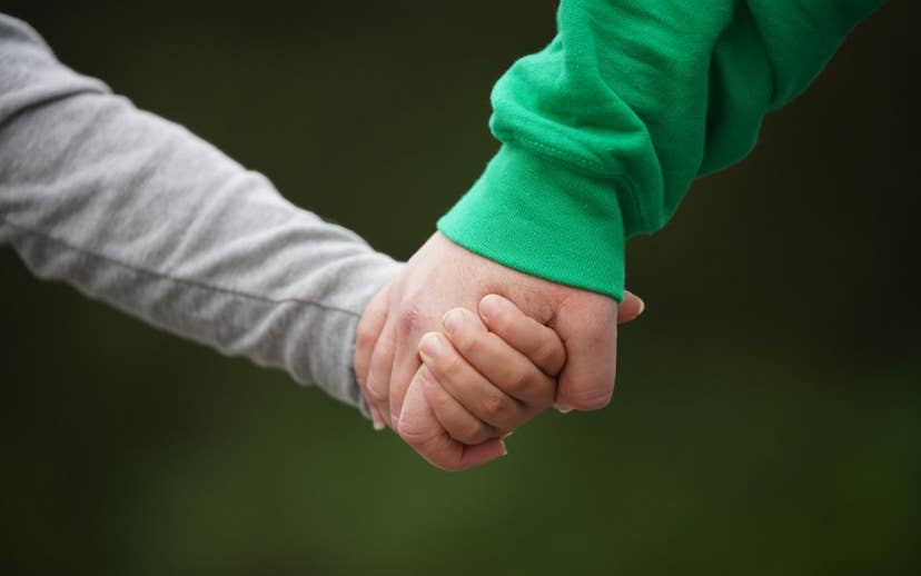 Youth and Adult Holding Hands