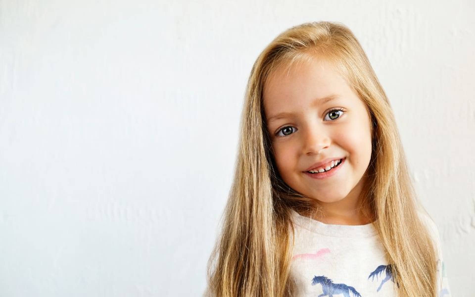 Young girl with head tilted and smiling