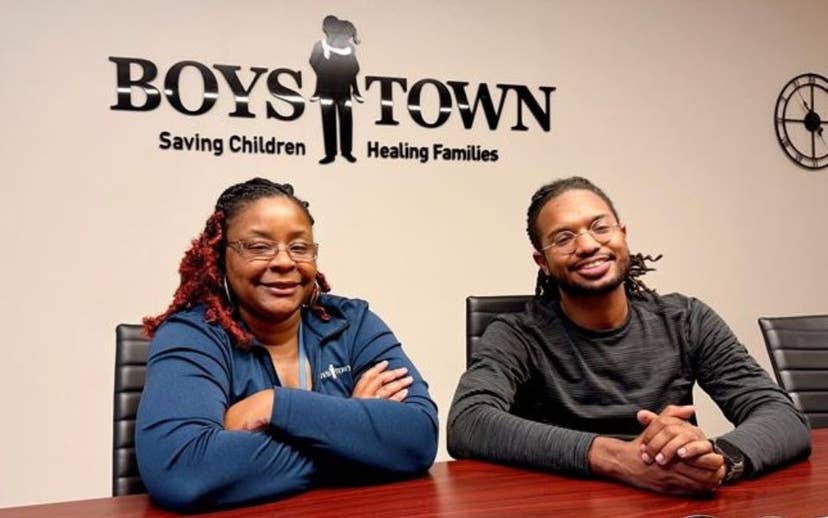 Mel and Nicholas sitting at a table smiling