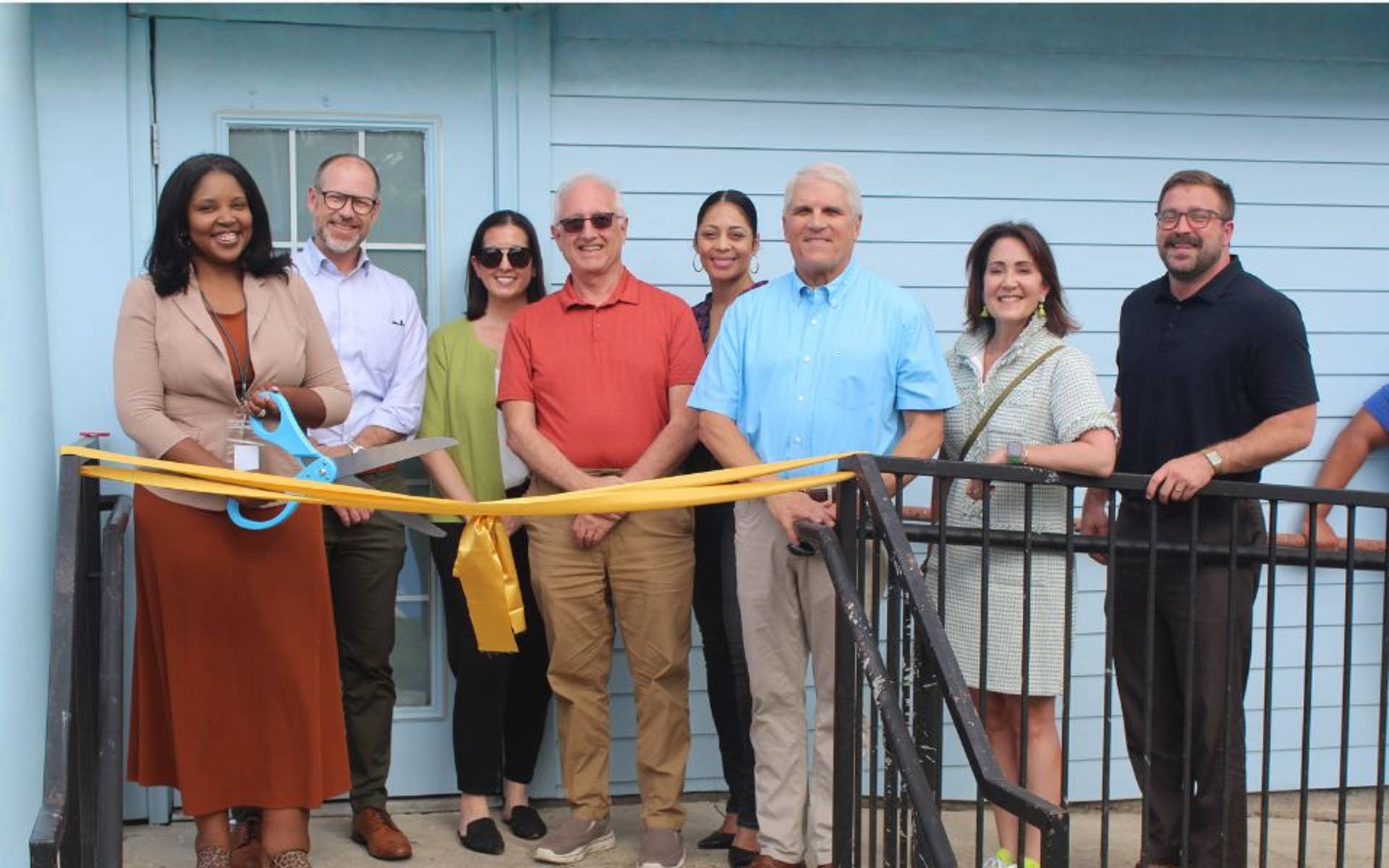 Group of adults at Ribbon cutting ceremony