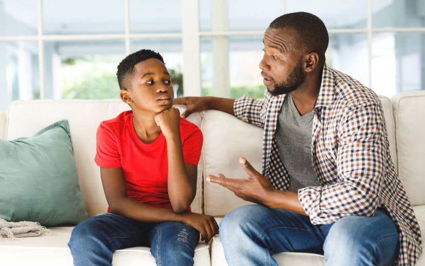 Dad sitting on couch listening to son