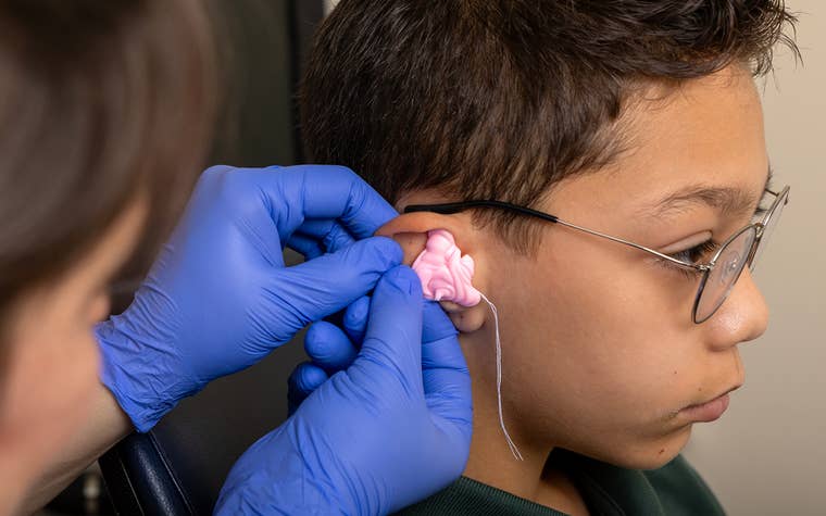Young boy getting fitted for a hearing aid