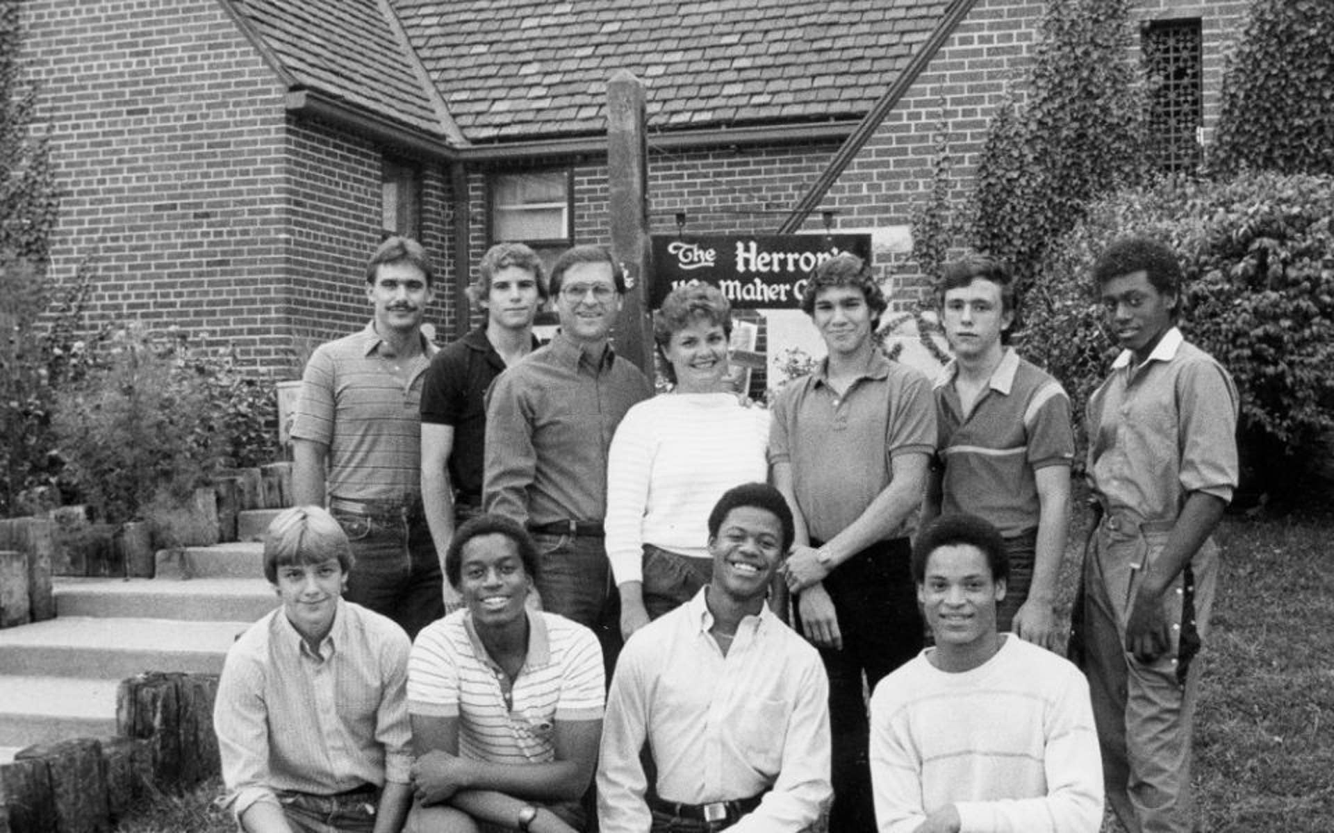 Black and white photo of a group of boys outside a family home