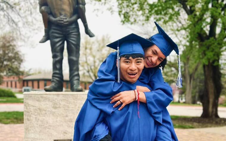 Two young men in graduation cap and gowns