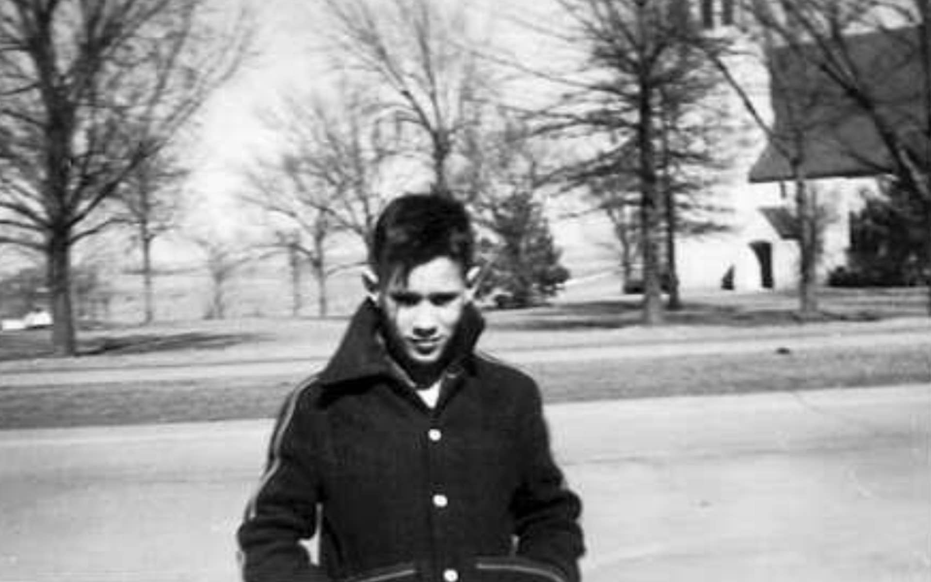 old black and white photo of a young boy outside 