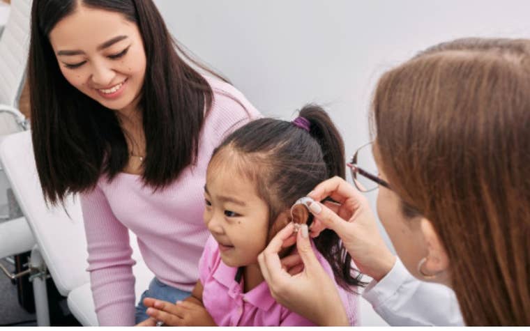 mom with daughter at an ear doctor appointment 