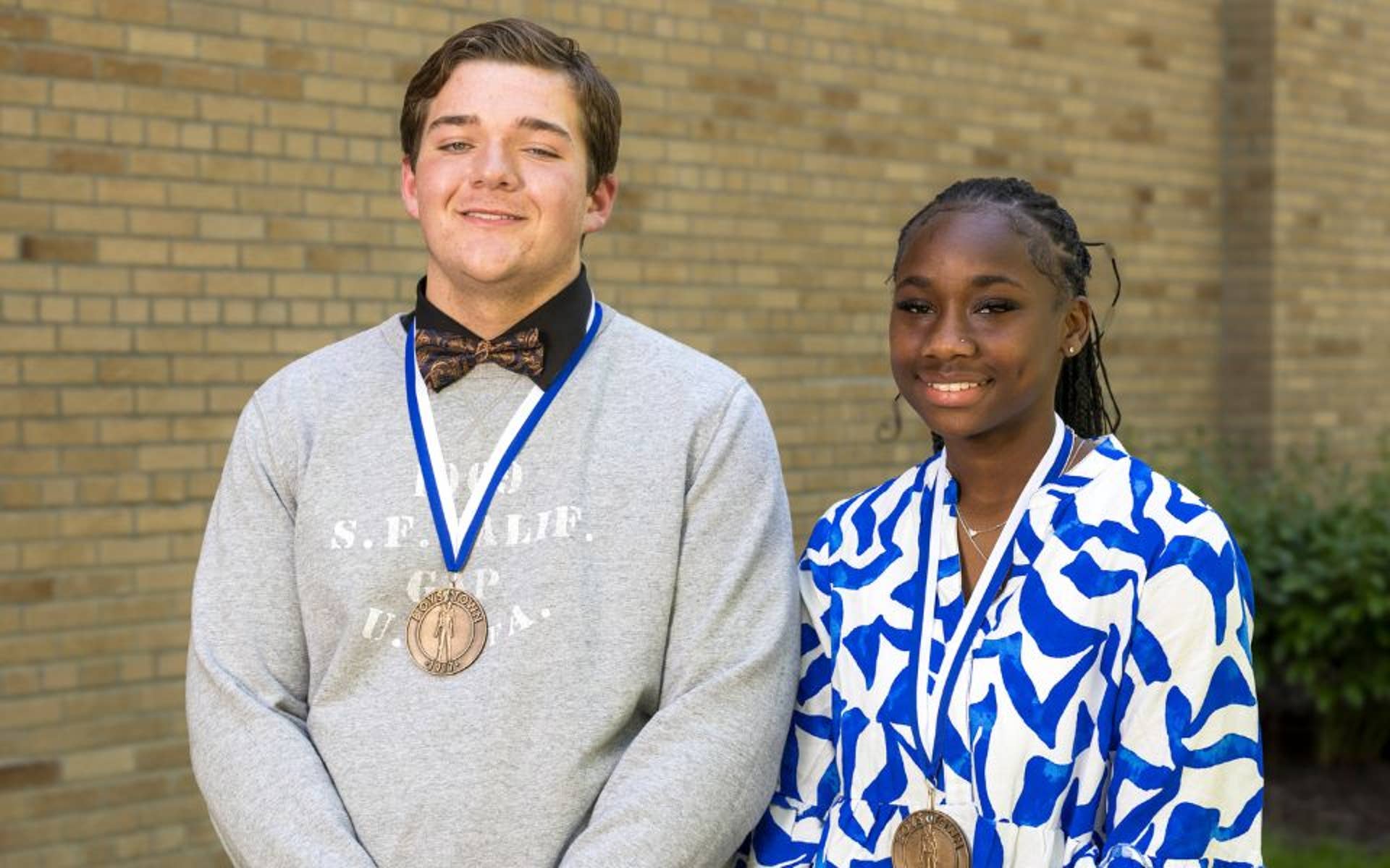 Young boy and girl wearing medals