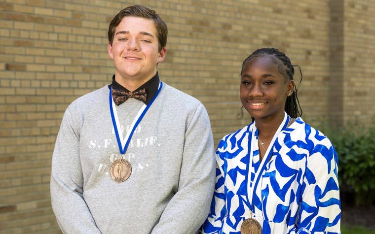 Young boy and girl wearing medals