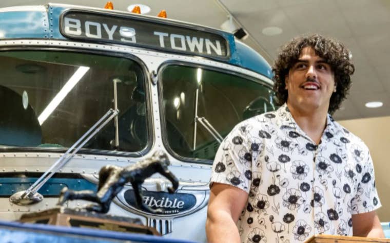 young man standing at a podium speaking 