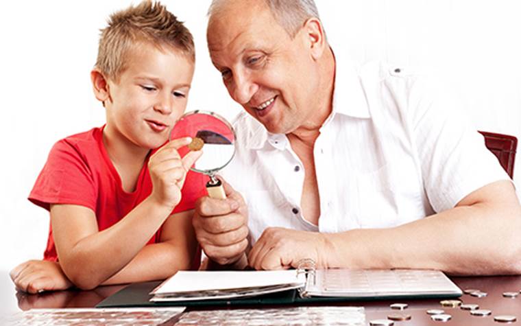 Grandfather showing son a coin