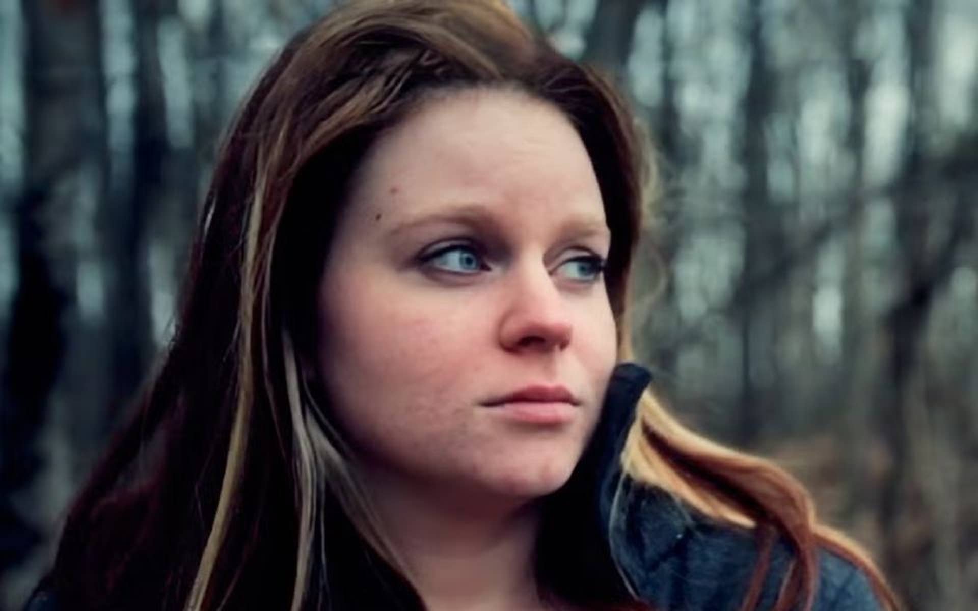 young girl outside looking sad