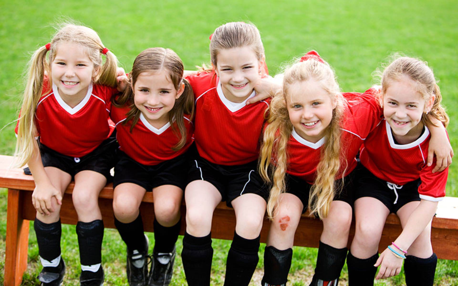 Young soccer players sitting on a bench