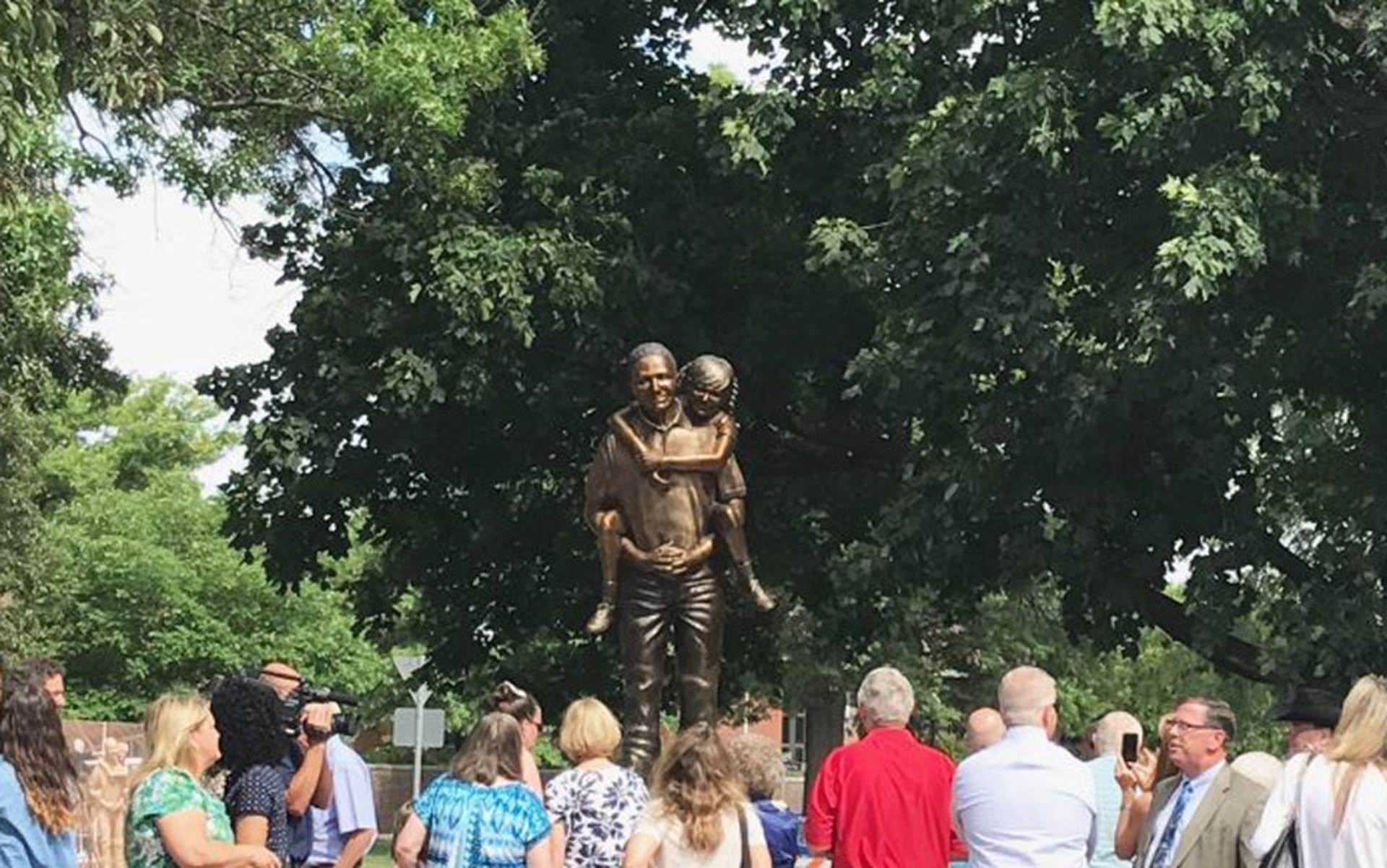 Crowd watching new statue being unveiled