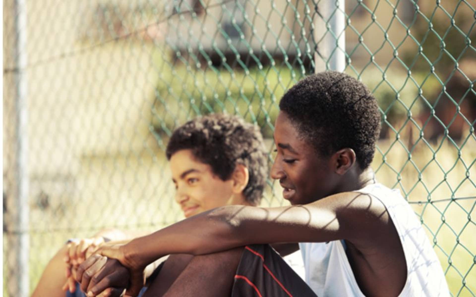 two boys hanging out outside