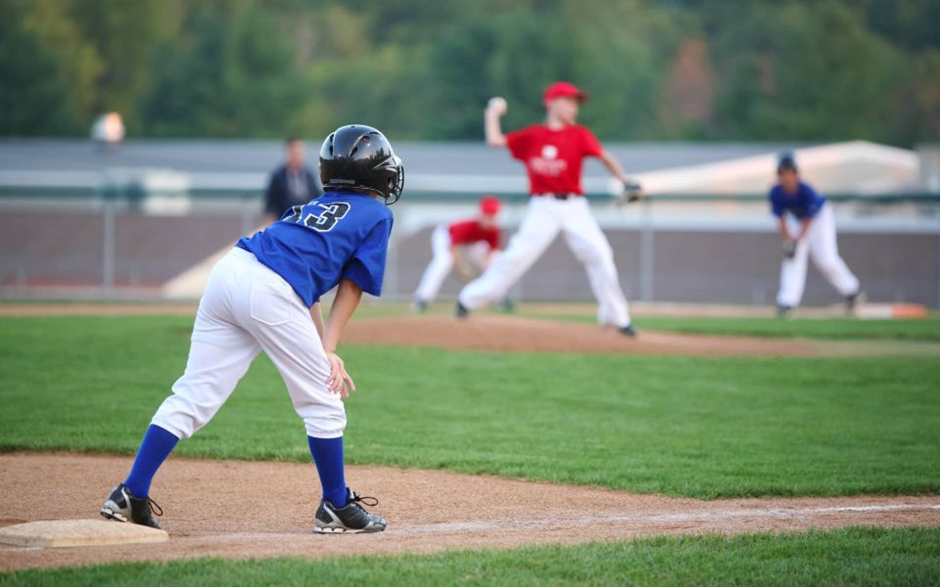 young children playing baseball outside