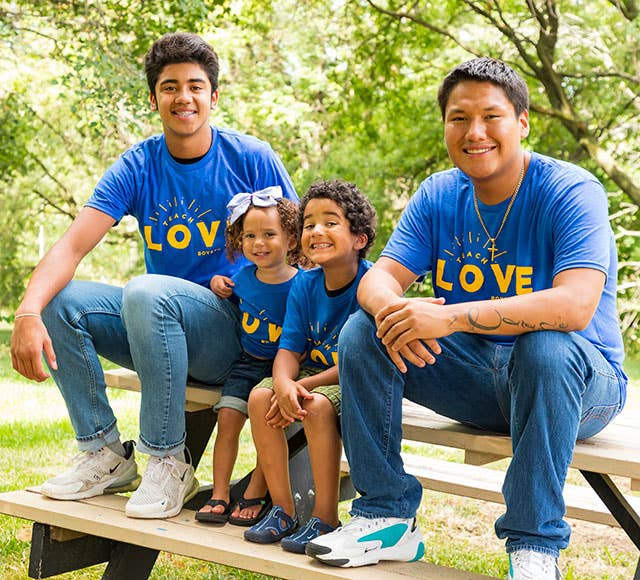 Foster kids sitting on a picnic table
