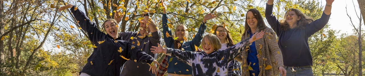 Boys Town Family playing in fall leaves