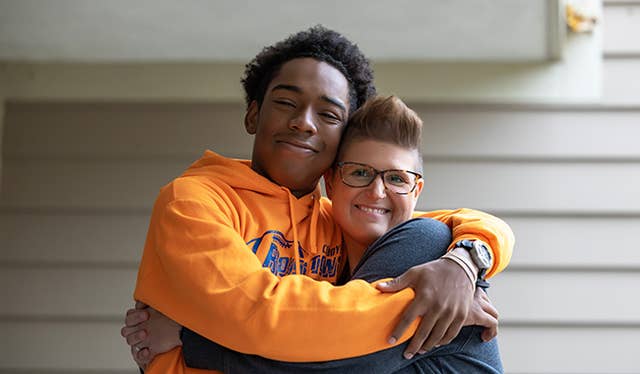 Young man hugging his Family Teacher