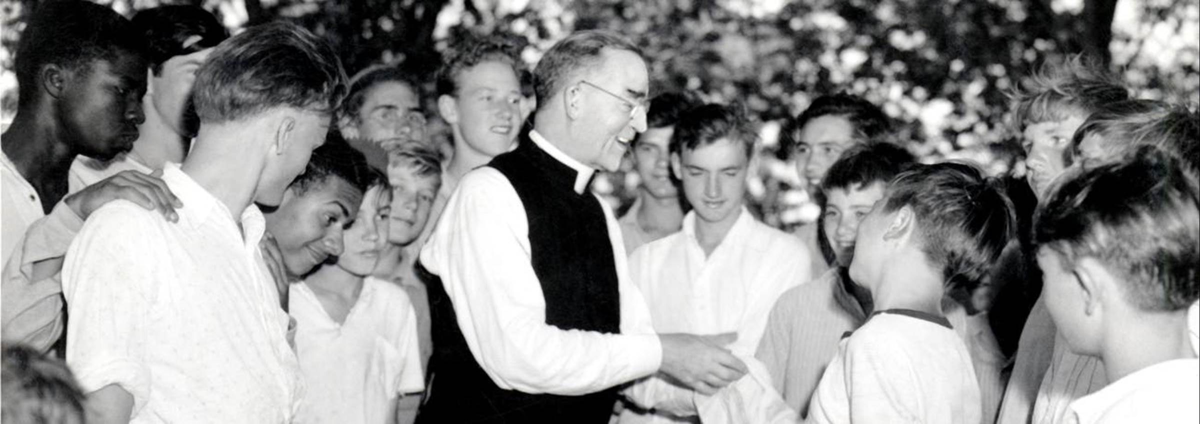 Father Flanagan smiling with several boys