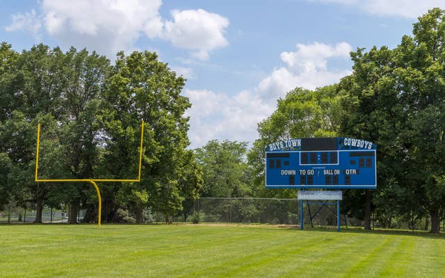 Football field with boys town scoreboard