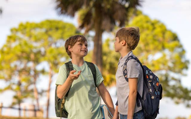 Two young boys with backpacks